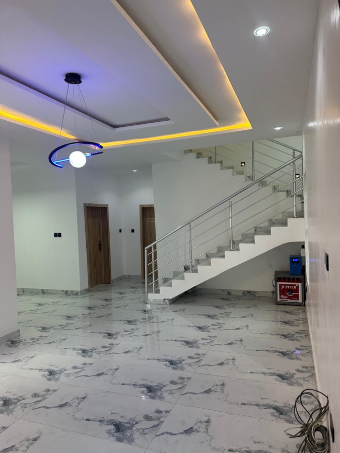 Open plan living area with staircase and LED ceiling