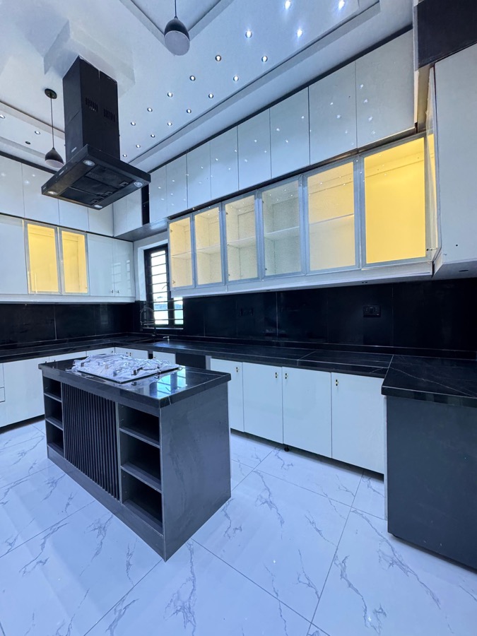 Large black and white fitted kitchen with island